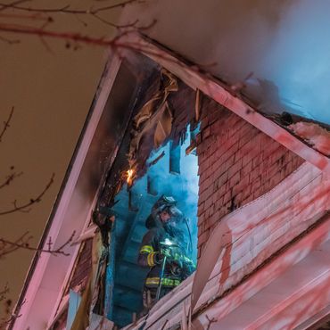 Firefighter alone in the attic after a fire.