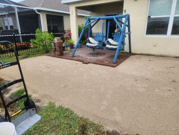 Blue wooden swing set with cushions on a patio.