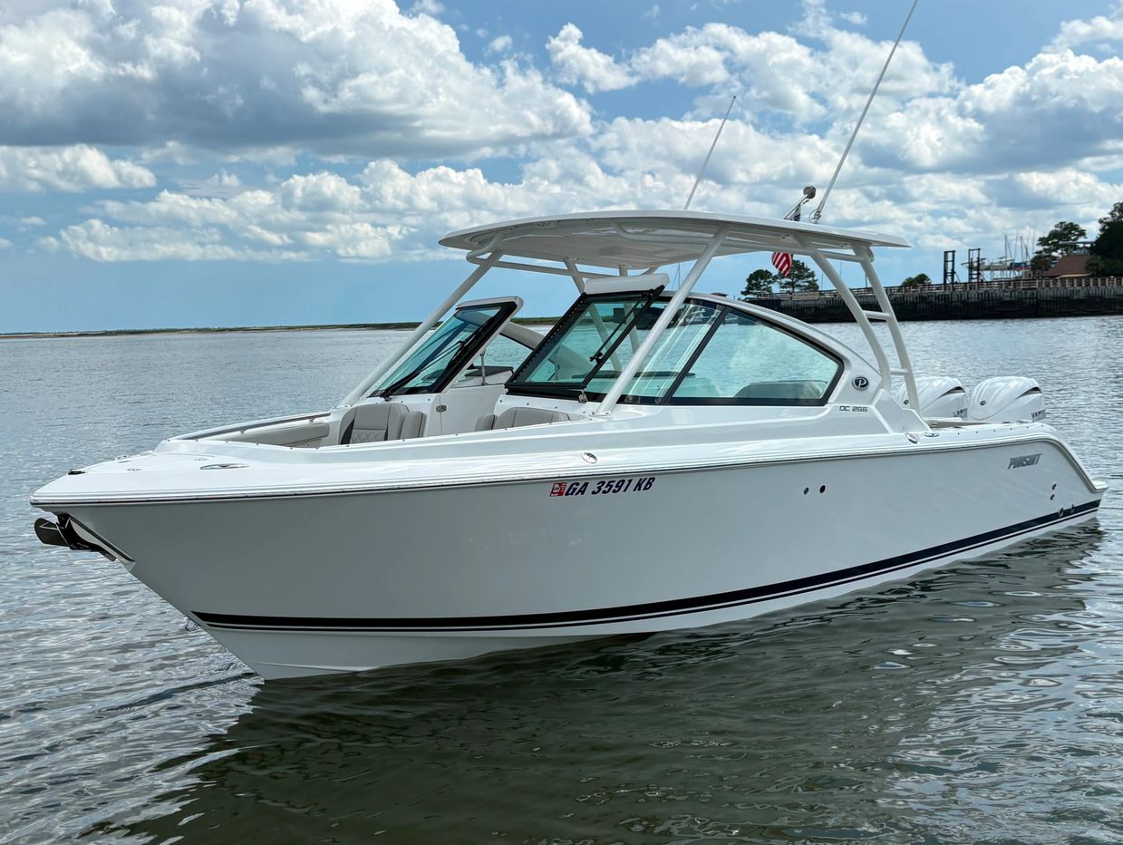 White motorboat floating on calm water.