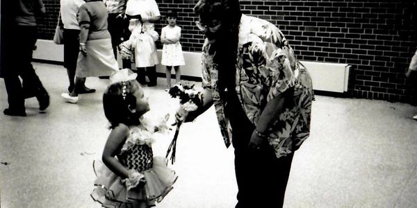 A black and white picture of a woman playing with a kid