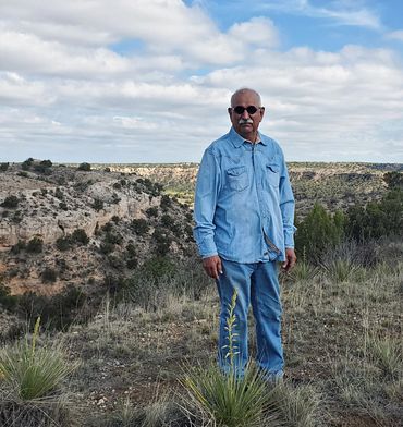 Robert Champion standing outside with canyon in background