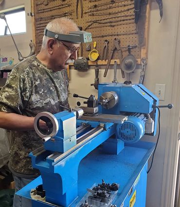 Robert Champion using his lathe in his knife shop