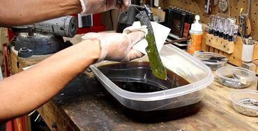 Robert Champion etching a Damascus knife blade