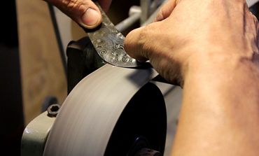 Robert Champion grinding a fixed blade knife blade