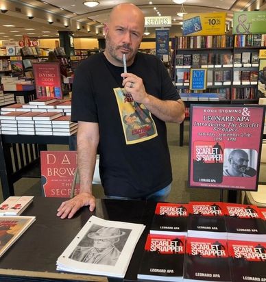 Author Leonard Apa at book signing event.