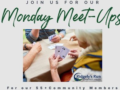 Older adults playing cards at a community meet-up.