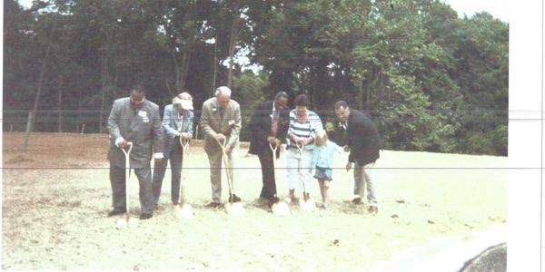 Group of people at a groundbreaking ceremony with shovels