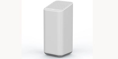 Modern white wireless speaker with perforated top.
