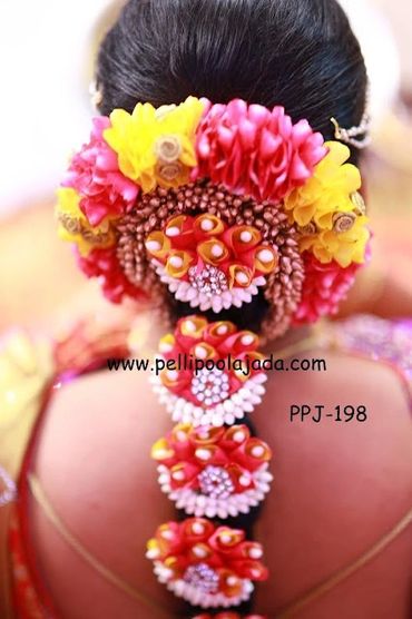 Beautiful poolajada with floral embellishments with nandhivardhanam buds with stone beads