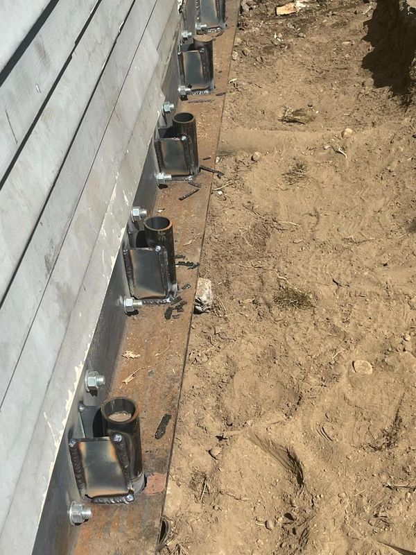 Continuous angle iron distributes the load along the length of the foundation