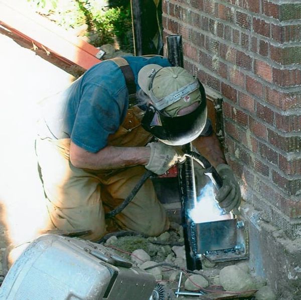 Welding brackets in the field to stabilize a chimney