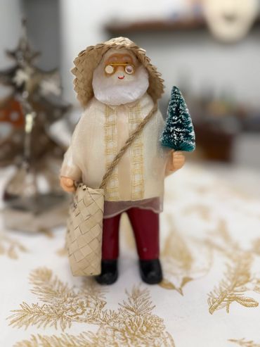 Pinoy Santa holding a Christmas Tree