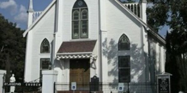 Front view of a white historic church building.