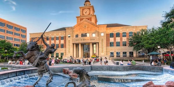 City hall with horseback rider statue and fountain.