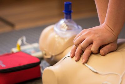 Image shows someone demonstrating CPR on an adult mannequin