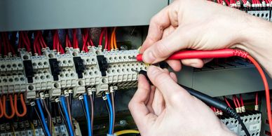 Electrician troubleshooting a panel board in Cuero, TX and surrounding areas