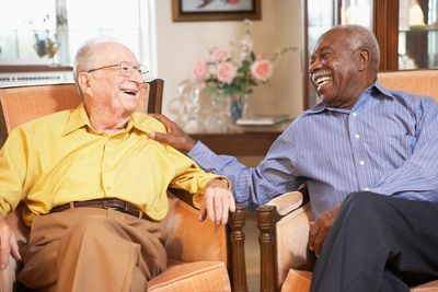 Two elderly men laughing together