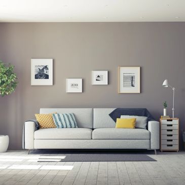 Living room with modern furniture and grey painted walls.