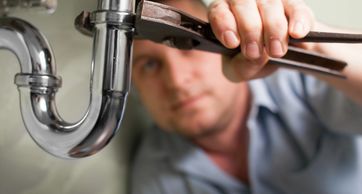 Plumbing repair handyman service fixing a leaky faucet