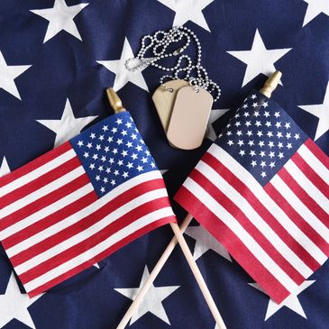 two us American flags and dog tags