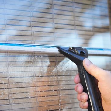 Using a Squeege to clean a window
CA Window Cleaning, Calif