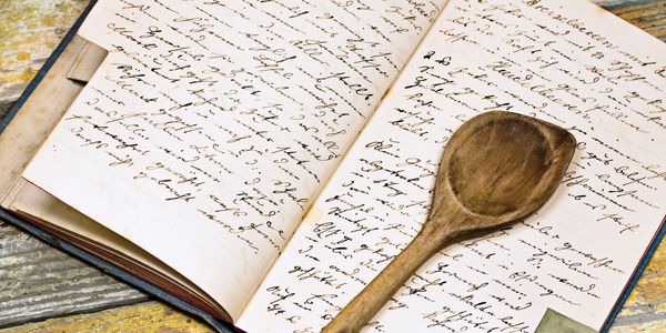 Recipe book with wooden spoon