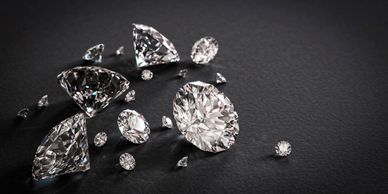 a handful of cut ring shape diamonds of all sizes on a grey background