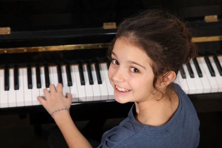 A child learning to play piano