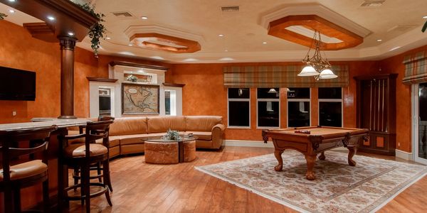 stylish recreation room with pool table and entertainment center