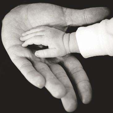Chula Vista, CA RCDA Testing - DNA Paternity test Baby touching dad's hand - Maternity testing