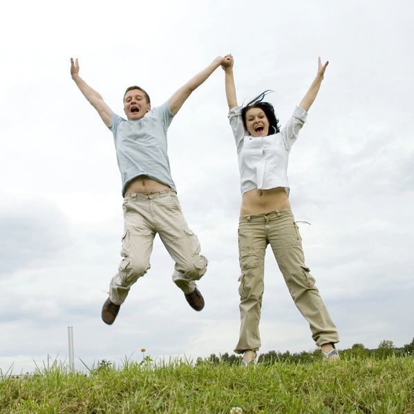 Woman and boy jumping happily