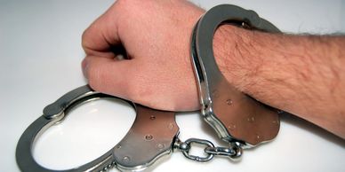 Hands in handcuffs at an arrest for criminal charges 