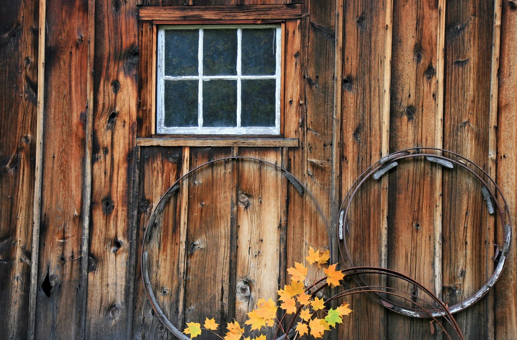 Rustic Building With Small Six Pane Window And Old Wheels In Lake Benton Minnesota