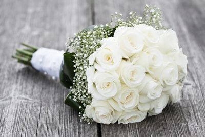 A white flower bouquet on the wooden floor