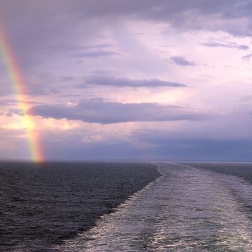 A sea and a rainbow in the sky