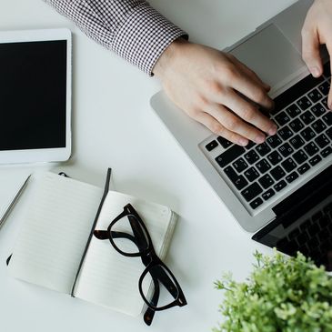 IT Consultant typing on laptop