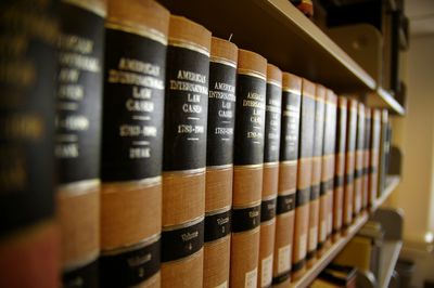 Photograph of volumes of law books depicting legal research and acumen
