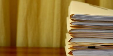 Stack of folders with papers on a desk