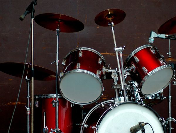 Set of drums with red accents in a studio