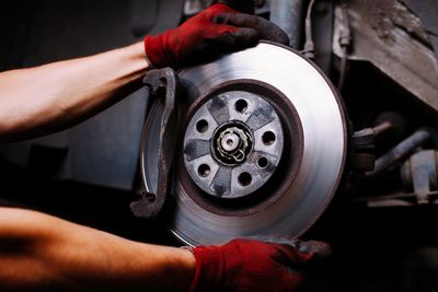 A mechanic changing a brake rotor on an automobile.