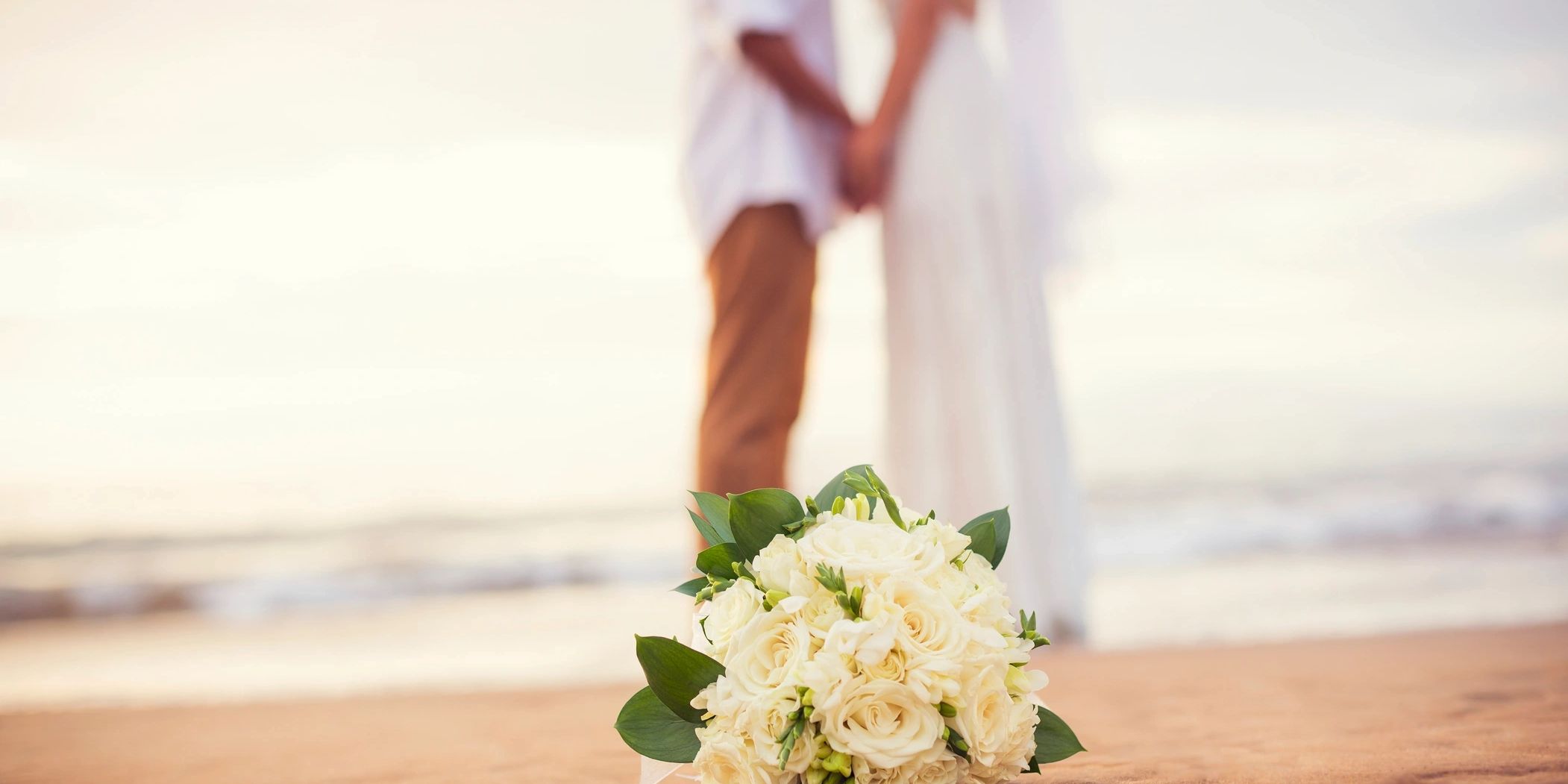 Romance novel happy ending of couple getting married on the beach.