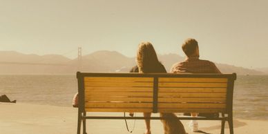 Couple on a bench, separated emotionally and physically. Couples Counselling available to reconnect.