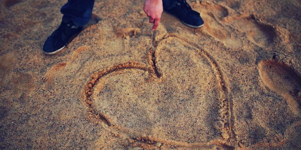 Heart drawn in the sand to illustrate design capabilities.
