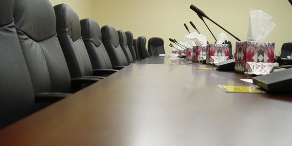 Conference microphones at meeting table.