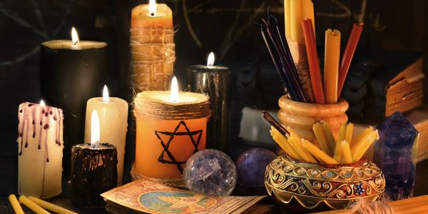Photo of candles, crystals, tarot cards. 