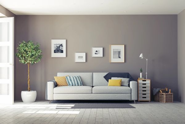 White modern sofa in a gray living room.