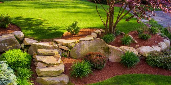 landscaping built with rocks and grass in a beautiful yard