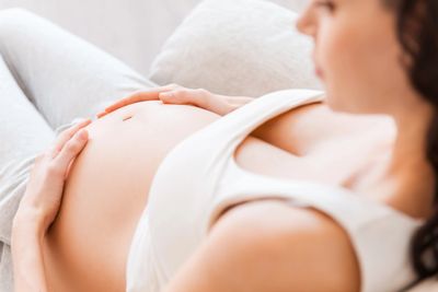 Pregnant woman with her hands on her belly