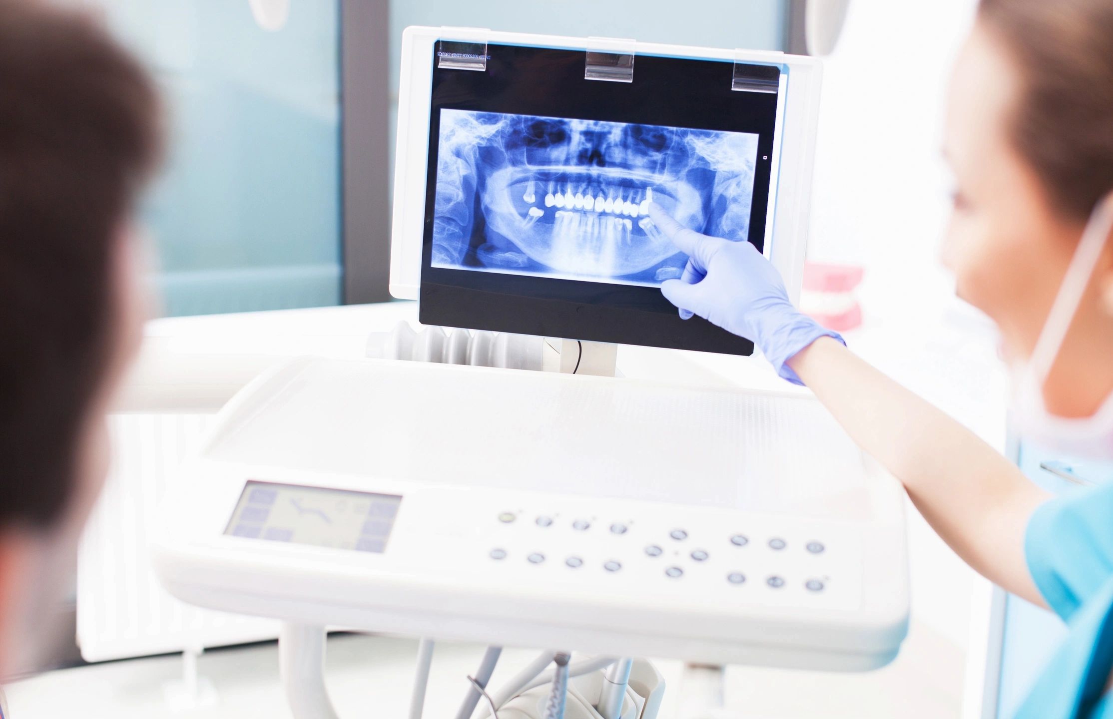 Image of the woman explaining Panoramic dental x-ray to a patient