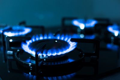 A picture of a stovetop burner in a darkened room.